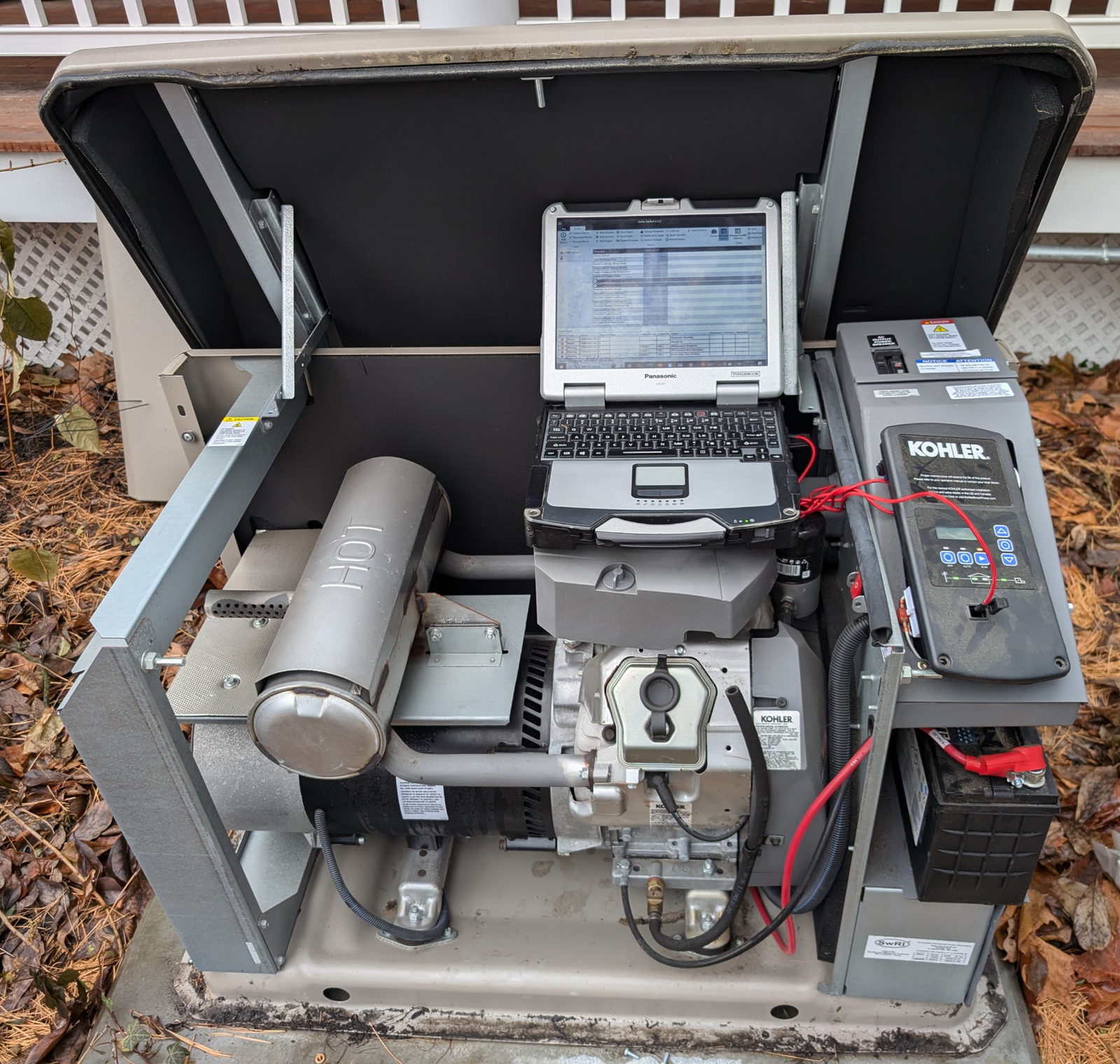 Inside a KOHLER standby generator showing the engine and battery
