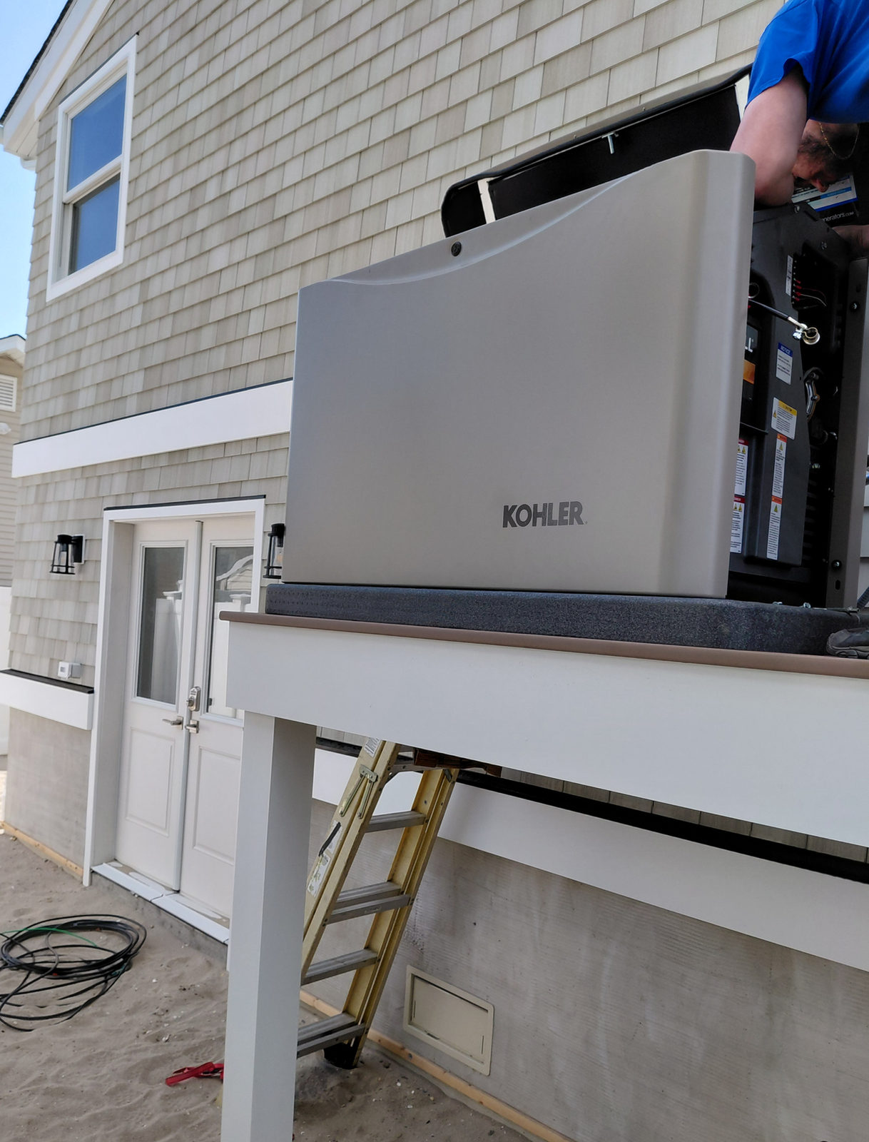 KOHLER standby generator installed on an elevated platform