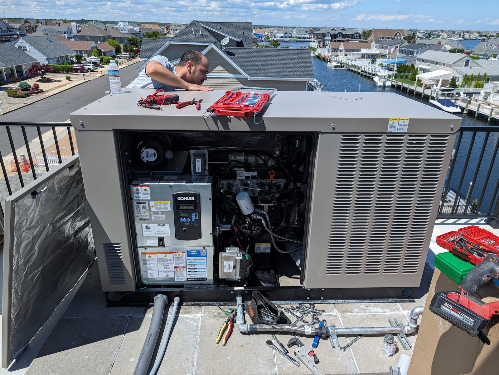 ADK technician working on a rooftop standby generator installation