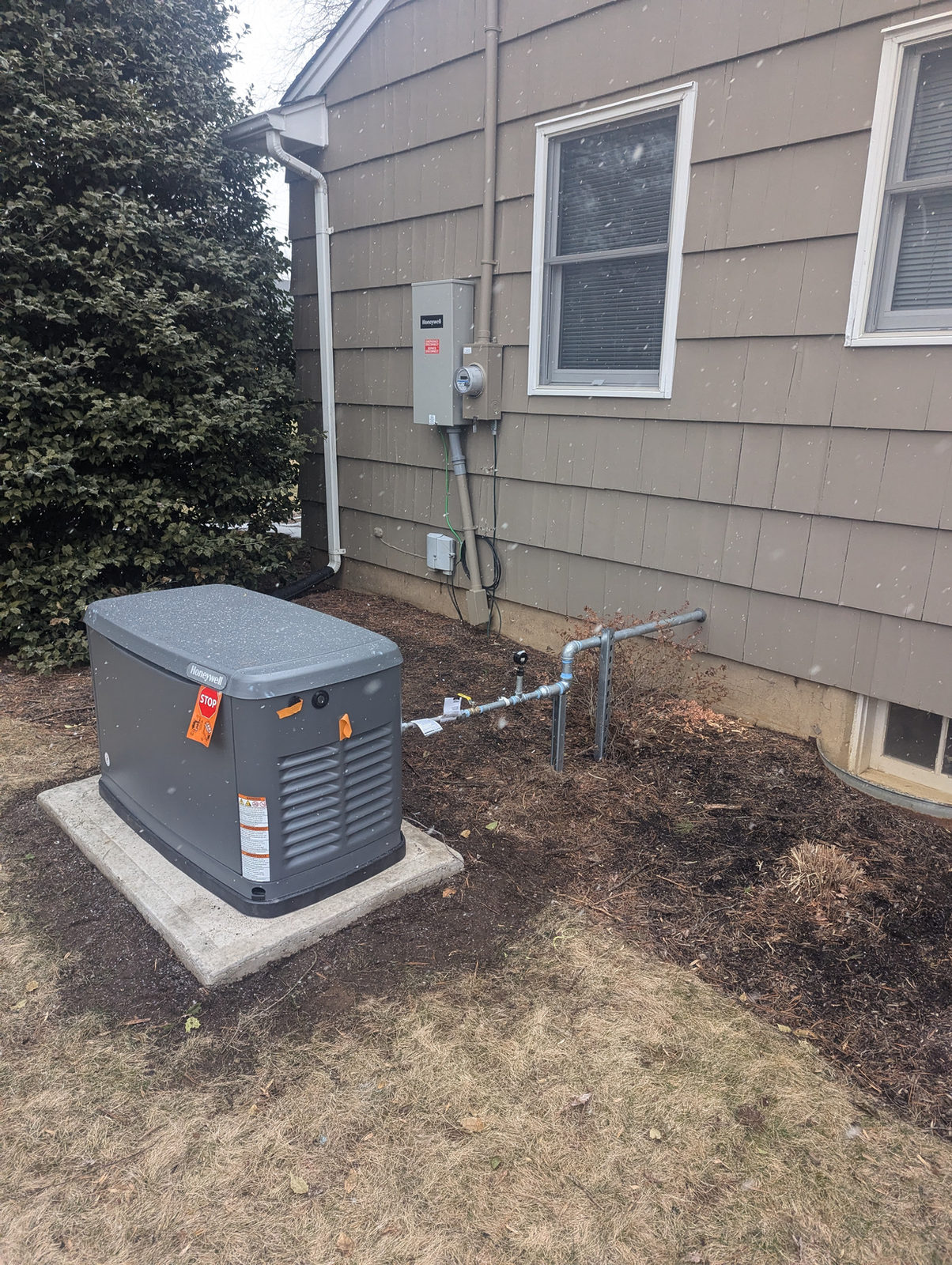 Completed Generac standby generator installation beside a New Jersey home