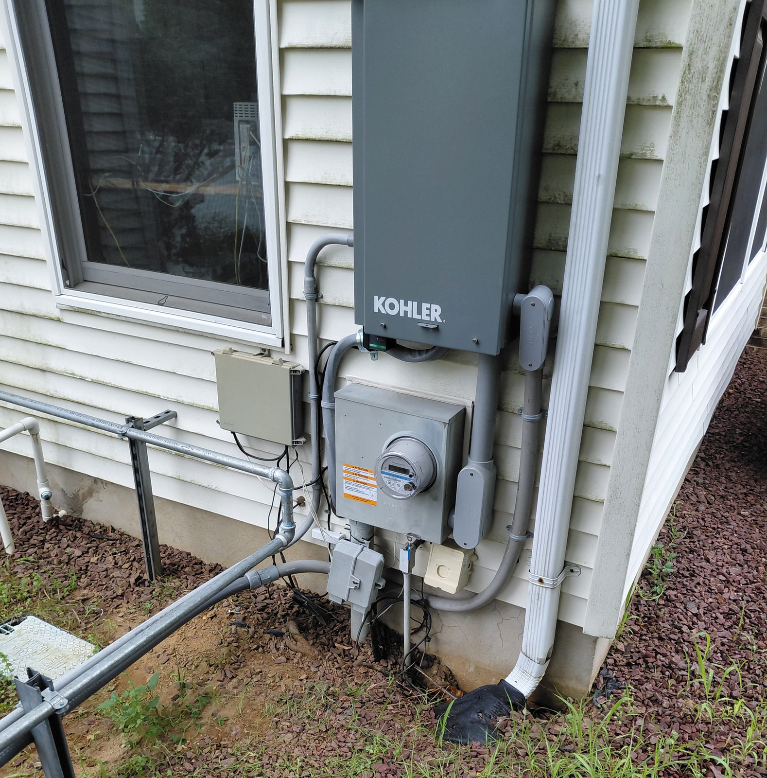 KOHLER generator and electrical equipment installed beside a home